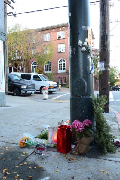 The makeshift memorial site set up across from City Center, near the place where four men were shot in a car double parked on Laguna Street.